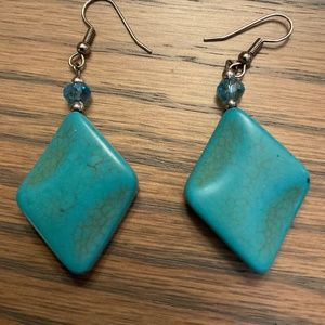 Earrings, turquoise in color, stone is approximately 1 1/2” long.